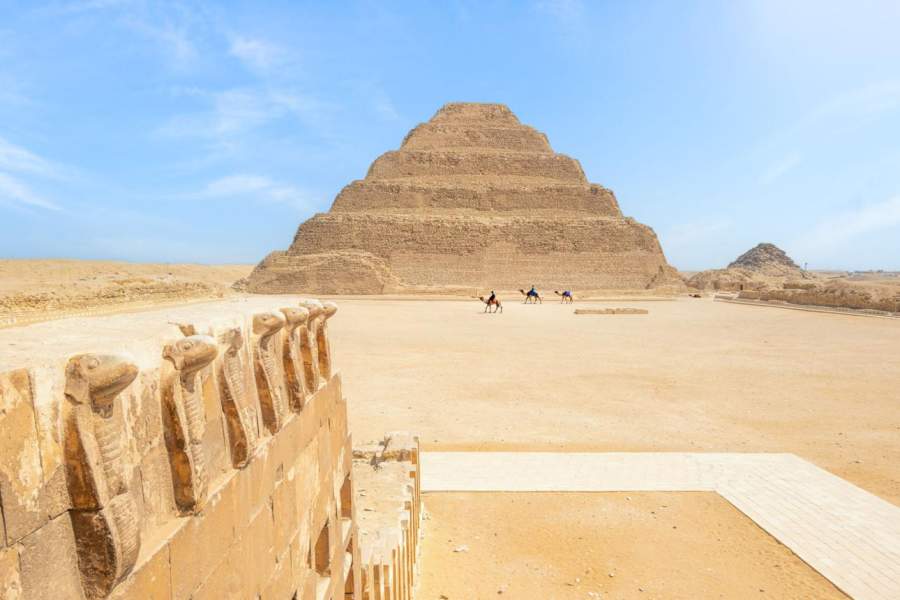 Men Riding Camels At The Step Pyramid, Sakkara, Egypt